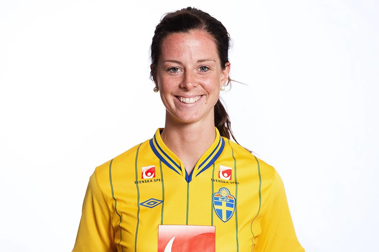 Lotta Schelin under en fotbollsmatch, klädd i mörkt matchtröja